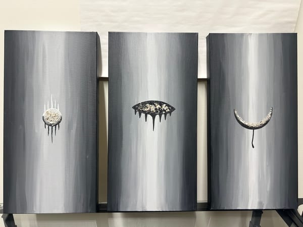 Three paintings in a grayscale gradient with different symbols on each displaying the different stages of Grief. Each symbol has cremains in it